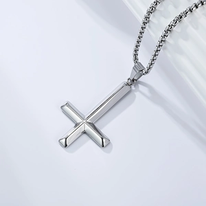Detailed view of polished stainless steel inverted cross pendant with high gloss finish
