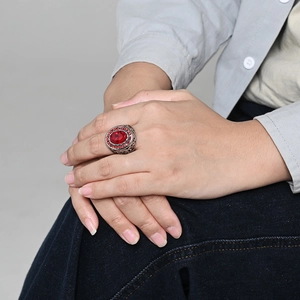 Vintage stainless steel ring for men featuring a large oval ruby with side carvings