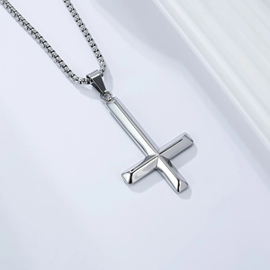 Macro detail of silver inverted cross pendant with robust steel box chain and sleek finish