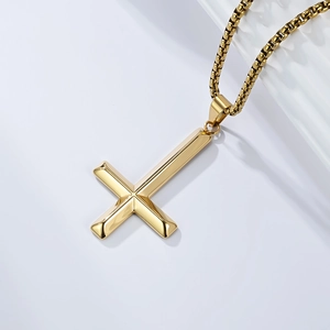 Detail of polished gold inverted cross pendant with a premium box chain necklace