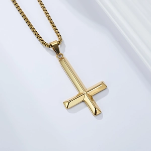 Detailed view of a gold inverted St. Peter's cross necklace with a polished box chain