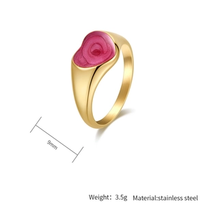 Detalle macro de un anillo de acero dorado 9mm con espiral de esmalte rosa