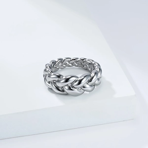 Macro detail of the twisted rope texture on a polished silver titanium steel ring