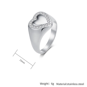 Macro shot of stainless steel signet ring with cubic zirconia stones and 13mm heart face