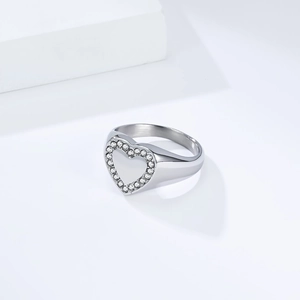 Macro shot of polished silver heart ring with sparkling crystal pave setting details