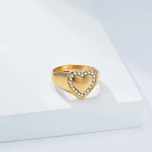 Detailed view of gold plated heart ring with sparkling micro-paved zircons and mirror finish