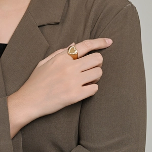 Elegant gold heart signet ring with micro-pave diamonds worn on finger for fashion look