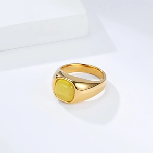 Polished gold stainless steel ring with square yellow cat eye stone on white stand