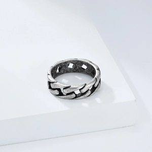Detailed view of silver Cuban link chain ring with oxidized matte finish on white block