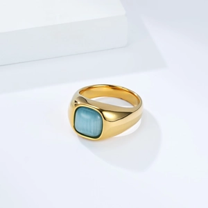 Detailed macro view of the gold-plated signet ring with a blue cat eye stone inlay