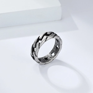 Detailed macro view of vintage silver cuban link chain ring with oxidized texture