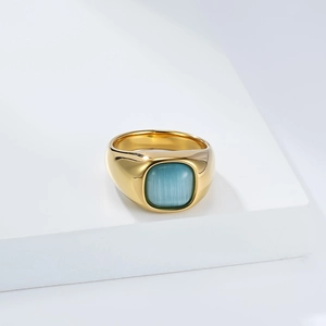 Detailed view of a gold-plated stainless steel signet ring with a blue cat-eye stone inlay