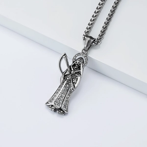 Close-up of Grim Reaper pendant with sparkling white zircons and silver wheat chain