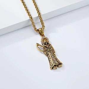 Gilded Santa Muerte pendant necklace with sparkling zircons on a white tiered base