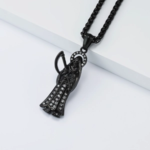 Macro detail of gothic grim reaper pendant with white crystal diamonds and black chain