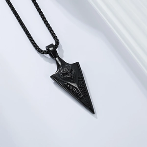 Close-up of a black matte stainless steel spearhead pendant with a carved eagle head