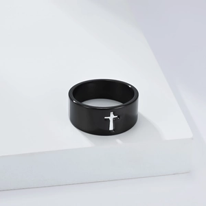 Macro shot of minimalist black polished ring featuring a hollowed-out cross design detail