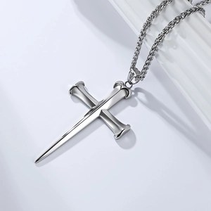 Detail of silver stainless steel cross pendant featuring a unique twin nail design on wheat chain