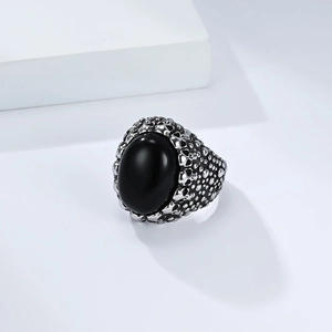 Detailed close-up of a vintage skull ring with a large oval black tiger eye stone