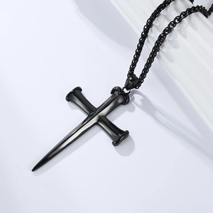 Detail of gothic punk black cross pendant with double nail design and wheat chain