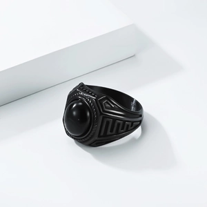 Macro view of men's vintage black gemstone ring with geometric engraved details