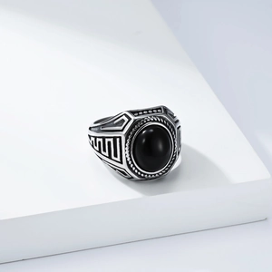 Macro side view of vintage men's silver ring with oval black onyx and geometric patterns