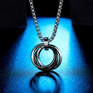 Macro detail of men's interlocking three-tone rings pendant with sparkling zircon accent