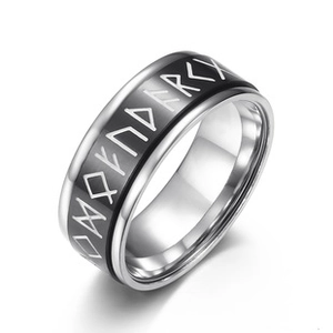 Detailed close-up of a silver stainless steel ring with black Norse rune engravings
