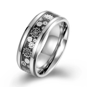 Detailed view of wide silver ring with black steampunk gear pattern and polished edges