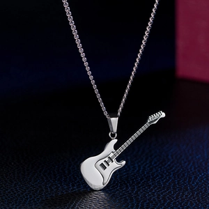 Close-up of silver guitar pendant with detailed strings and pickup textures on leather