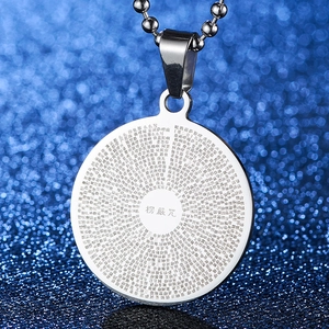 Macro shot of stainless steel pendant featuring laser-engraved Shurangama Mantra text