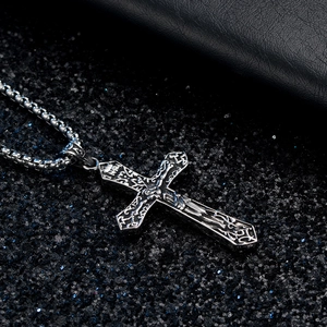 Vintage silver Jesus crucifix cross necklace with engraved details on a box chain