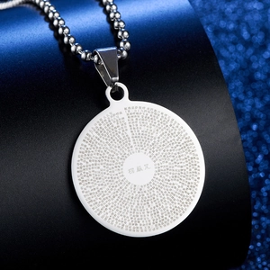 Detailed laser engraving of Shurangama Mantra on a polished stainless steel round pendant