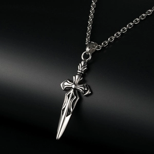 Macro detail of vintage silver sword cross pendant with sharp metallic texture