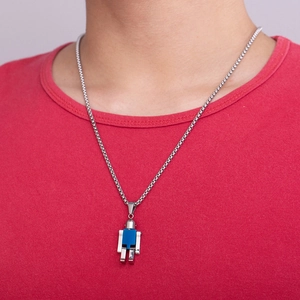 Close-up of a blue and silver mechanical robot pendant worn over a bright red shirt