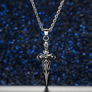 Detailed view of vintage silver sword cross pendant with gothic vine relief textures
