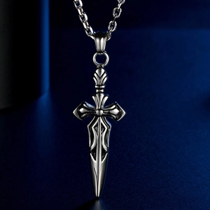 Macro detail of gothic stainless steel sword cross pendant with intricate engraving
