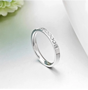 Elegant rose gold minimalist ring with sparkling cubic zirconia on a white background
