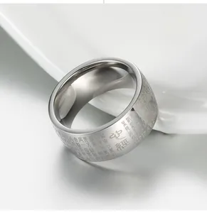 Macro shot of silver buddhist heart sutra ring with intricate engraved religious characters