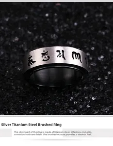 Macro detail of spinning titanium steel ring with engraved Tibetan symbols on black sand