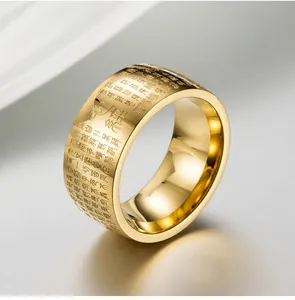 Macro shot of gold-plated wide band ring with engraved Buddhist Heart Sutra scriptures