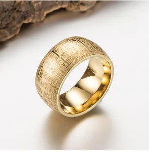 Macro shot of gold stainless steel ring with detailed Buddhist scriptures engraving