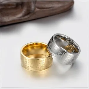 Close-up of gold and silver Buddhist Heart Sutra rings with engraved scripture text