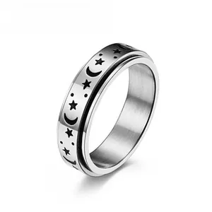 Macro detail of silver stainless steel rotating ring with brushed finish and moon star pattern
