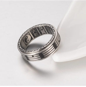 Macro detail of Taoist Tai Chi Yin Yang symbols and Bagua icons engraved on vintage ring