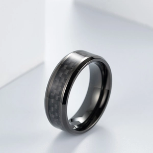 Macro shot of black titanium steel ring featuring carbon fiber checkered inlay and beveled edges