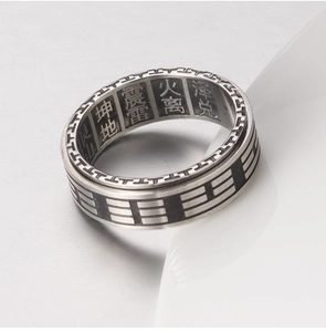 Close-up of vintage Yin Yang Bagua ring showing detailed engraved symbols and characters