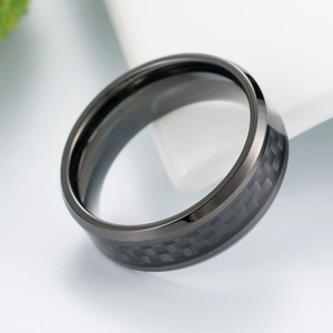 Close-up of titanium steel ring featuring black carbon fiber inlay and polished finish