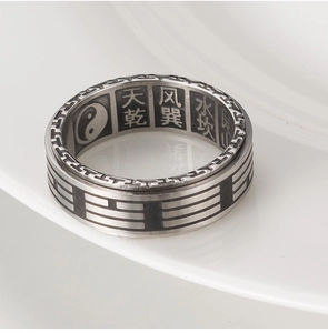 Macro detail of vintage Tai Chi Yin Yang ring with Bagua symbols and Chinese engraving