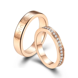 Detailed close-up of rose gold couple rings featuring engraved name and pavé set diamonds